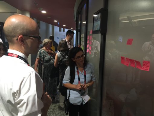 People discussing and looking at sticky notes